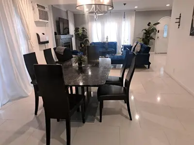 a dining room and living room with a table and chairs at Amazing 3 bedrooms with 3 bedroom apt in the center of Beverly Hills in Los Angeles