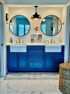 a blue bathroom with two sinks and two mirrors at Peace of Paradise - Heated Pool, Spa & Fireplace in Simi Valley