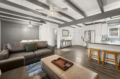 a living room with a couch and a table at Mockingbird Retreat - Walk to the Lake, hot tub, EV charger, Fenced yard. in Big Bear Lake