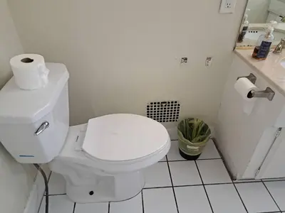 a white bathroom with a toilet and a sink at 3 bedroom plus 2 baths in Beverly hills in Los Angeles