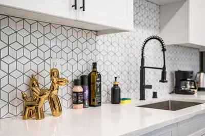 a kitchen counter with bottles of wine and a sink at Newly Remodeled 2BR Apt | Mins to Disney | Arcade in Placentia