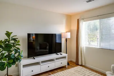 a living room with a large flat screen tv on a wall at BBQ Ready Home 7 Mi to The Park at River Walk in Bakersfield