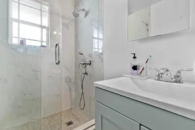 a white bathroom with a sink and a shower at Luxury Pool Oasis- Near Stadium, Tennis and Golf in Pasadena