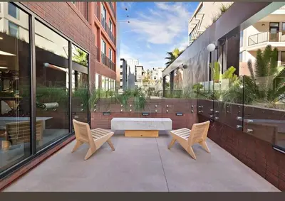 a courtyard with two chairs and a tub in a building at Modern Hollywood Apt with Pool Spa & Great Views in Los Angeles