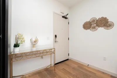 a hallway with a console table and a door at Modern Hollywood Apt with Pool Spa & Great Views in Los Angeles