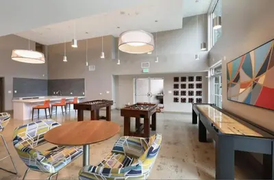 a large room with ping pong tables and chairs at Modern Hollywood Apt with Pool Spa & Great Views in Los Angeles