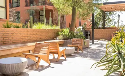 a group of chairs and tables in a courtyard at Modern Hollywood Apt with Pool Spa & Great Views in Los Angeles