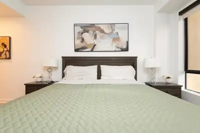 a bedroom with a large bed with two night stands at Walk to Santa Monica Beach & Pier Boardwalk in Los Angeles
