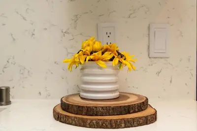 a vase with yellow flowers in it on a table at Walk to Santa Monica Beach & Pier Boardwalk in Los Angeles