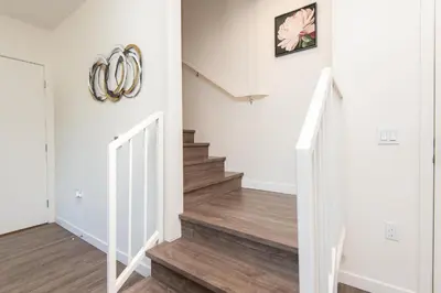 a hallway with stairs with areath on the wall at Snazzy 3BR Apt Hollywood with Pool & Spa in Los Angeles
