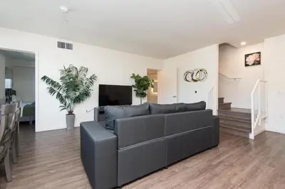 a living room with a couch and a tv at Snazzy 3BR Apt Hollywood with Pool & Spa in Los Angeles
