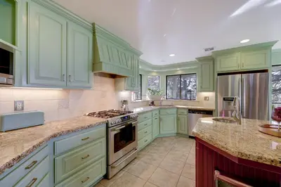 a green kitchen with green cabinets and appliances at Mtn and Valley Views! Rimforest Lodge with Fireplace in Rimforest