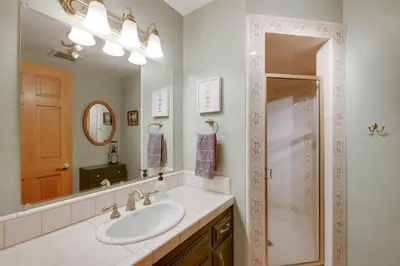 a bathroom with a sink and a shower and a mirror at Mtn and Valley Views! Rimforest Lodge with Fireplace in Rimforest