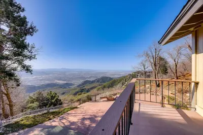 a balcony of a house with a view of the mountains at Mtn and Valley Views! Rimforest Lodge with Fireplace in Rimforest