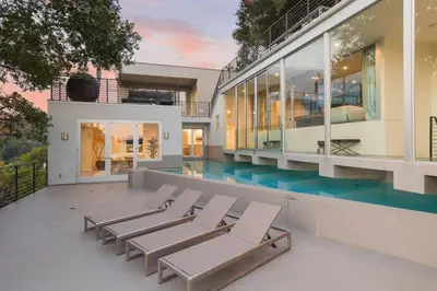 a building with a swimming pool and a row of chairs at Spacious 4BR Retreat with Private Pool, Pool Table and Fast Wi-Fi Sleeps 9 Quiet Clinton Location in Beverly Hills