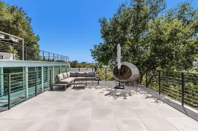 an outdoor patio with a bench and a hammock at Spacious 4BR Retreat with Private Pool, Pool Table and Fast Wi-Fi Sleeps 9 Quiet Clinton Location in Beverly Hills