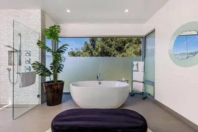 a bathroom with a large tub and a potted plant at Spacious 4BR Retreat with Private Pool, Pool Table and Fast Wi-Fi Sleeps 9 Quiet Clinton Location in Beverly Hills