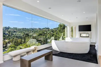 a living room with a white couch and a large window at Spacious 4BR Retreat with Private Pool, Pool Table and Fast Wi-Fi Sleeps 9 Quiet Clinton Location in Beverly Hills