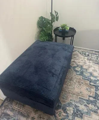a black mattress sitting on a floor next to a table at Cozy beautiful 2 bedroom home at the beach in Los Angeles