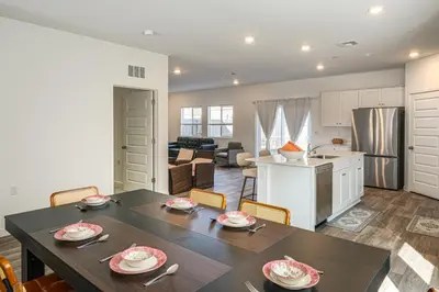 a kitchen and living room with a table and chairs at Pet-Friendly Yard! Family Home in Bakersfield in Bakersfield