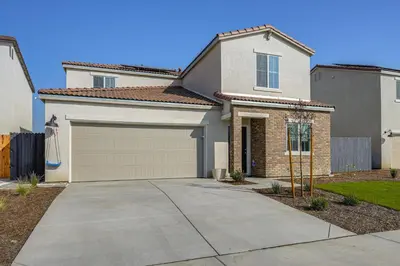 a house with a garage and a driveway at Pet-Friendly Yard! Family Home in Bakersfield in Bakersfield