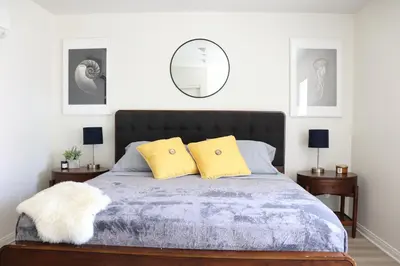 a bedroom with a bed with two yellow pillows at Promenade Studio With Free Parking in Los Angeles