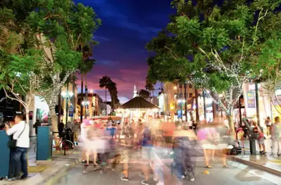 a crowd of people walking down a city street at night at Promenade Studio With Free Parking in Los Angeles