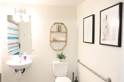 a bathroom with a toilet and a sink and a mirror at Promenade Studio With Free Parking in Los Angeles