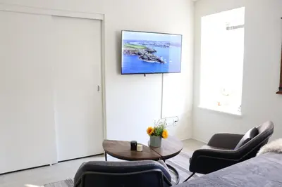 a living room with a tv on a wall at Promenade Studio With Free Parking in Los Angeles
