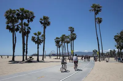 a group of people riding bikes on the beach at Promenade Studio With Free Parking in Los Angeles