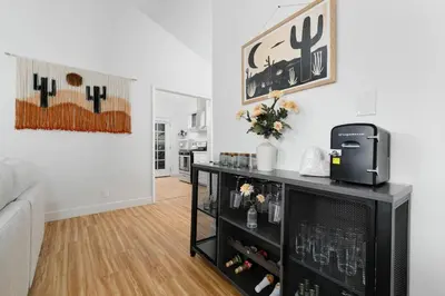 a living room with a table with a tv at Mar Vista 2BR Retreat Office Huge Backyard in Los Angeles