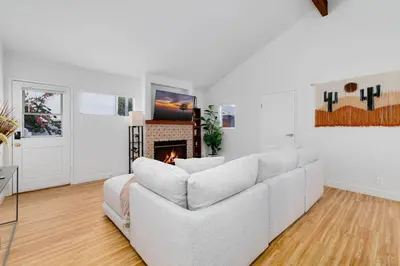 a living room with a white couch and a fireplace at Mar Vista 2BR Retreat Office Huge Backyard in Los Angeles