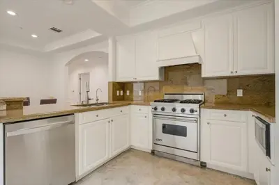 a white kitchen with white cabinets and a stove at Los Angeles Beverly Hills Westside UCLA Luxury in Los Angeles