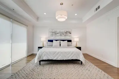 a white bedroom with a bed and two lamps at Los Angeles Beverly Hills Westside UCLA Luxury in Los Angeles