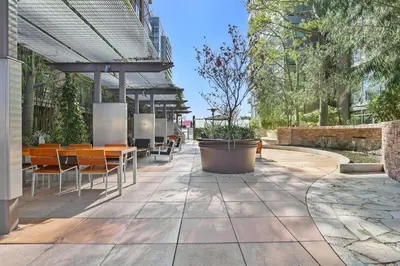 a patio with tables and chairs in a building at Luxe DTLA Escape - Walk to Games, Events, & Dining in Los Angeles