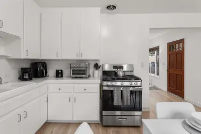 a kitchen with white cabinets and a stove at Relax in Stylish 3BR with Fire Pit Gym and Parking in Los Angeles