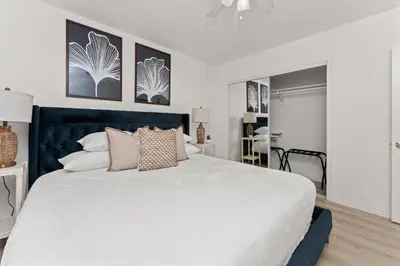 a bedroom with a large white bed with pillows at Relax in Stylish 3BR with Fire Pit Gym and Parking in Los Angeles