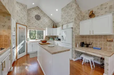 a kitchen with white cabinets and a white refrigerator at Deer Creek Lodge Mtn Getaway in Lake Arrowhead! in Lake Arrowhead