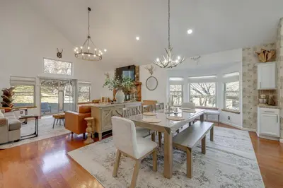 a dining room and living room with a table and chairs at Deer Creek Lodge Mtn Getaway in Lake Arrowhead! in Lake Arrowhead