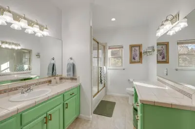 a bathroom with two sinks and a toilet at Deer Creek Lodge Mtn Getaway in Lake Arrowhead! in Lake Arrowhead