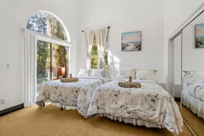 a bedroom with two beds and a window at Hillside Retreat Near Universal Studios & Hollywood Sign in Los Angeles