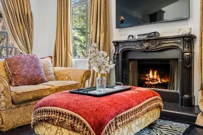 a living room with a couch and a fireplace at Hillside Retreat Near Universal Studios & Hollywood Sign in Los Angeles