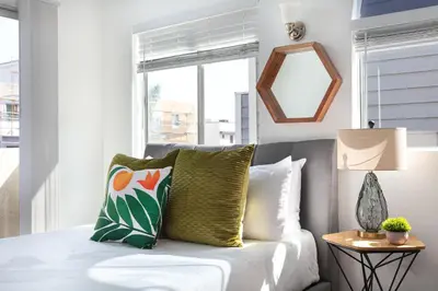 a living room with a couch and a mirror at Luxury 4BR Townhouse Sleeps 10 with Parking in McNeil