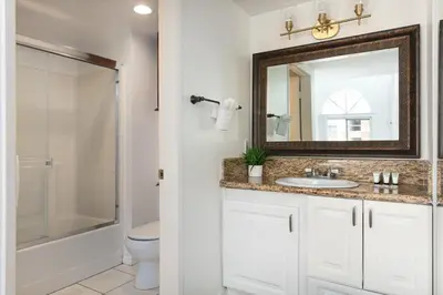 a bathroom with a sink and a mirror at Luxury 4BR Townhouse Sleeps 10 with Parking in McNeil