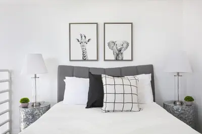 a bedroom with two pictures of giraffes and a bed at Luxury 4BR Townhouse Sleeps 10 with Parking in McNeil