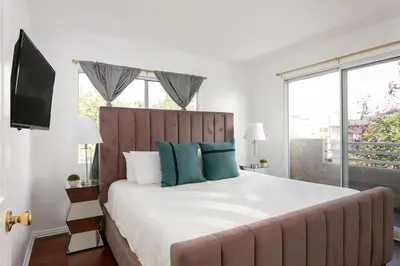 a bedroom with a large bed with blue pillows at Luxury 4BR Townhouse Sleeps 10 with Parking in McNeil