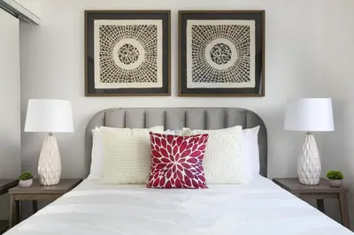 a bedroom with a white bed with two lamps at Luxury 4BR Townhouse Sleeps 10 with Parking in McNeil