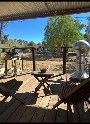 a patio with a table and chairs on a wooden deck at Zaromelranch