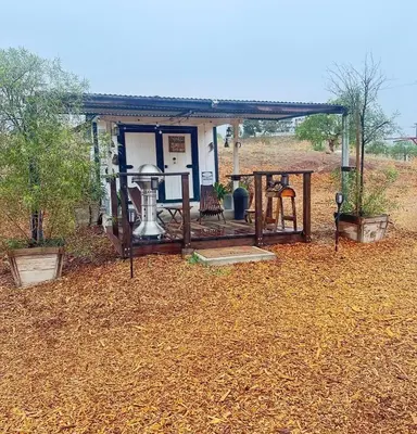 a small house with a table and chairs in a field at Zaromelranch