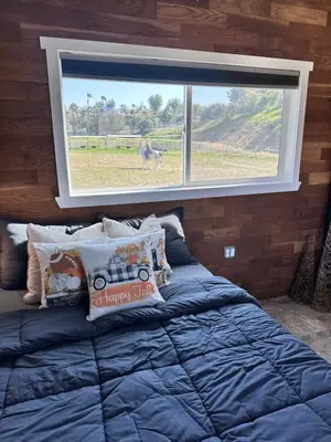 a bed in a room with a large window at Zaromelranch